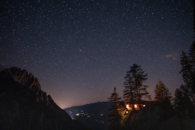 Night view of chalets with gentle outdoor lighting and starry sky.