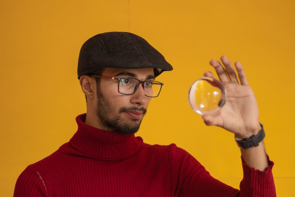 man wearing eyeglasses and red sweater