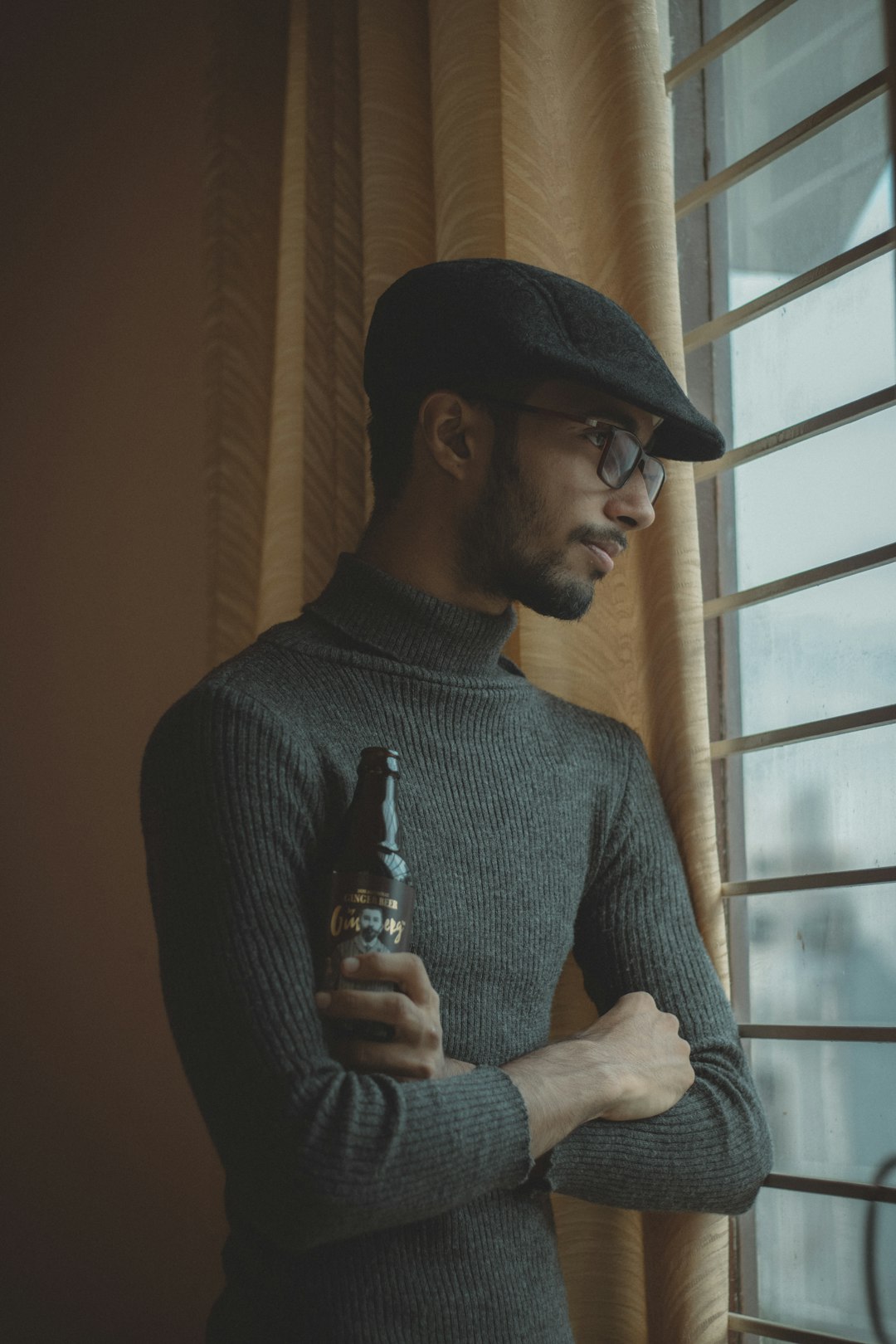 man wearing black beret and gray turtleneck sweater