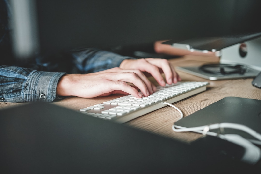 Marketing professional using desktop software for newsletter