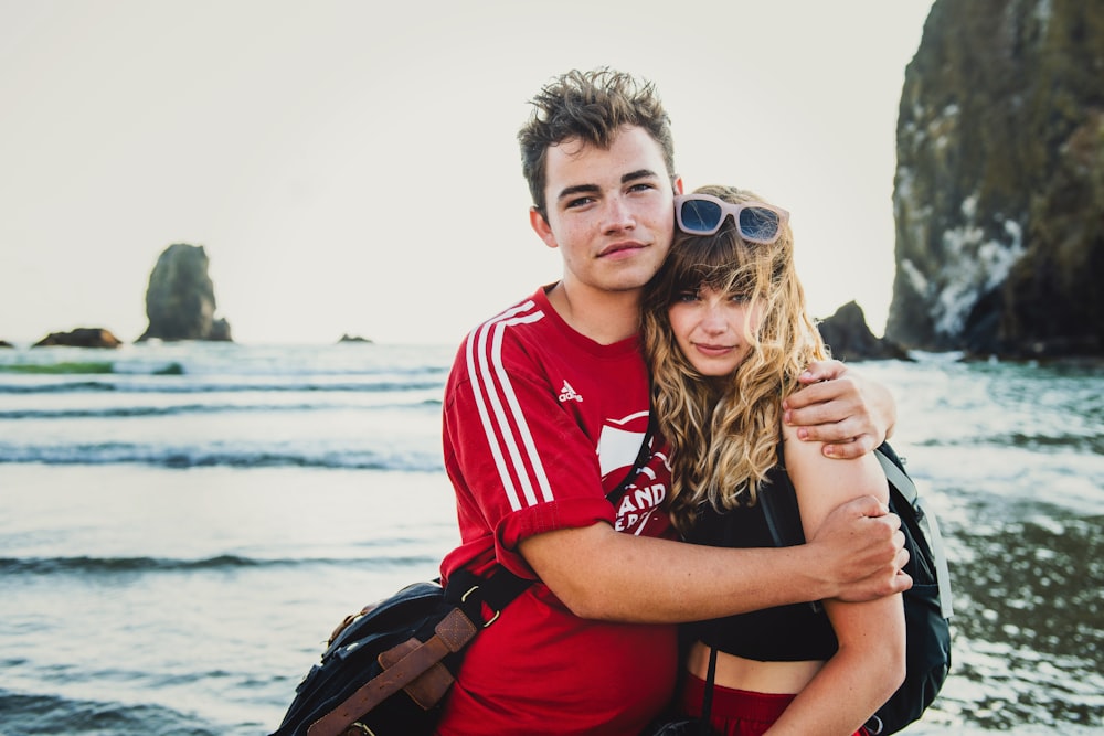 hugging couple by sea at daytime