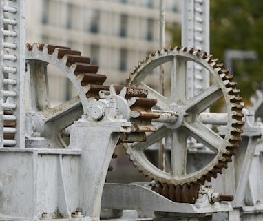 selective focus photography of machine with gears