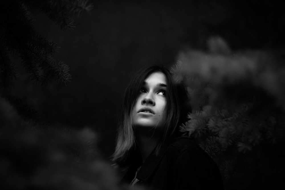 grayscale photo of woman looking at sky