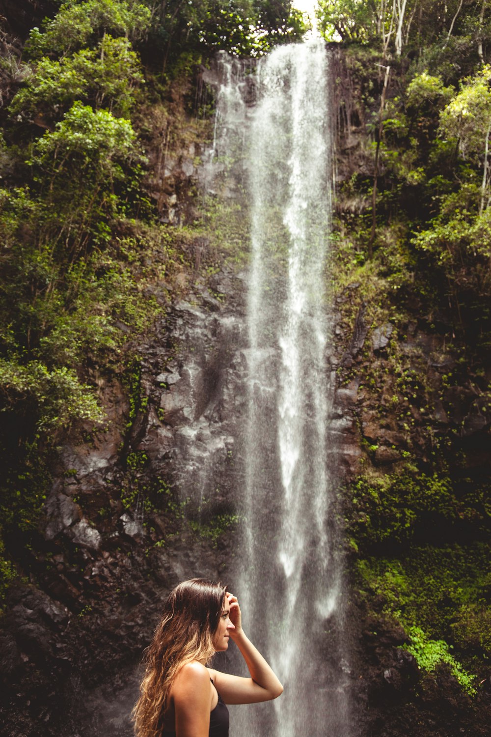 woman wearing black top across waterfalls