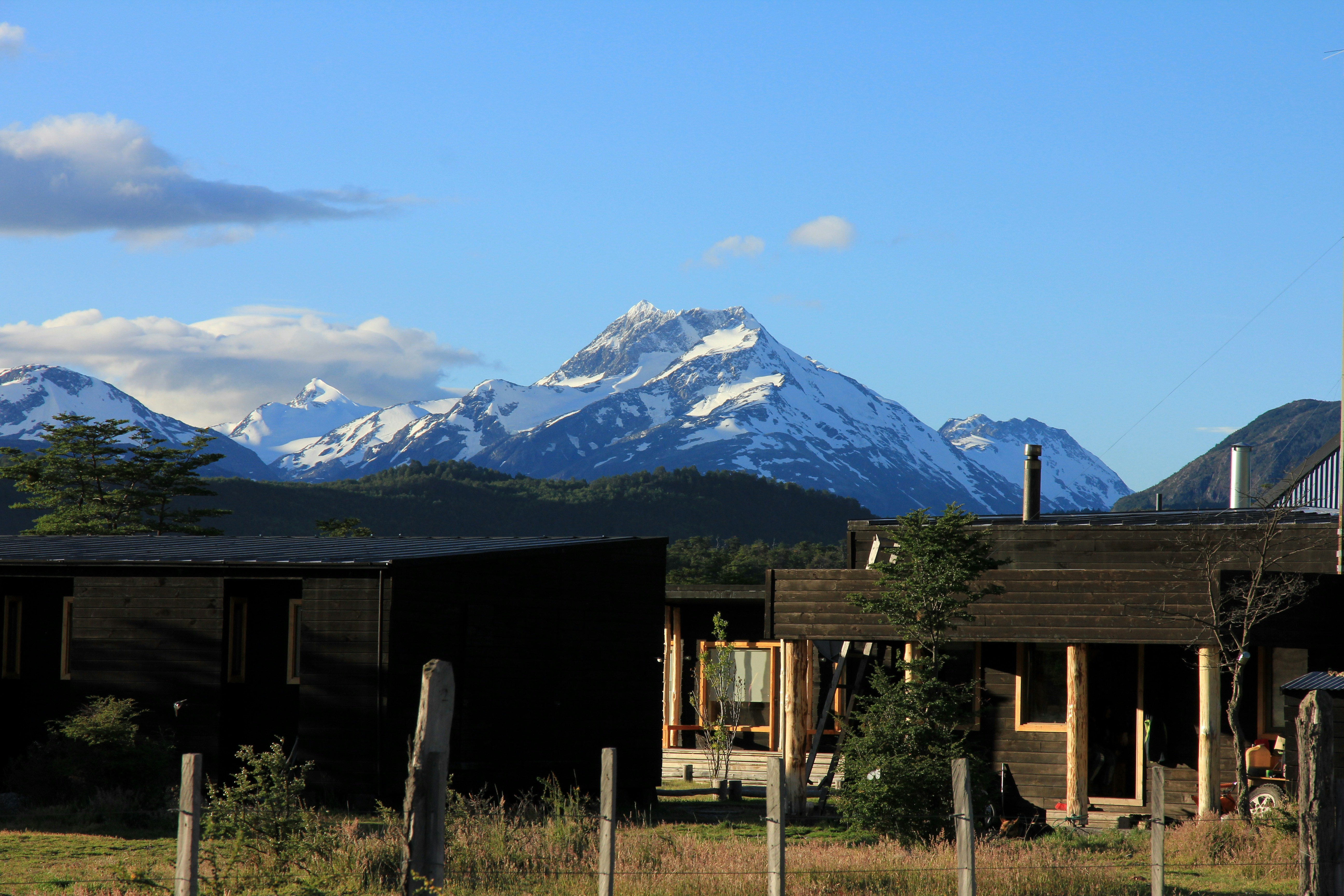 brown house near snow-capped mountain