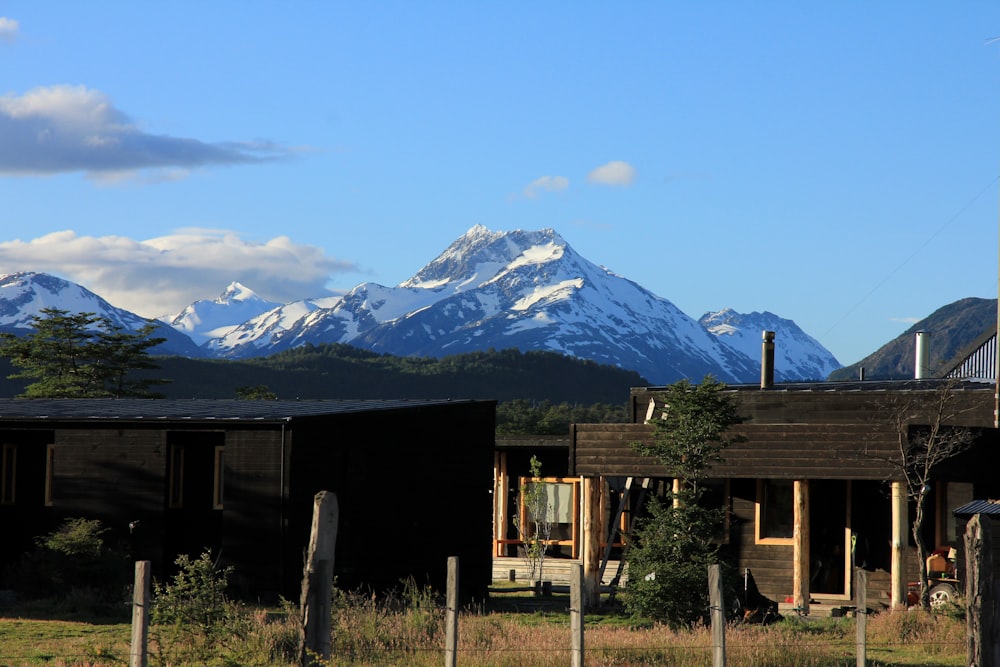brown house near snow-capped mountain