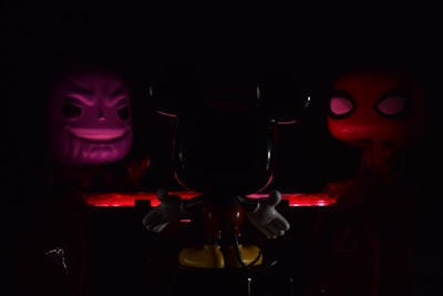A trio of duality characters standing against a dark starry background, highlighting their divided faces.
