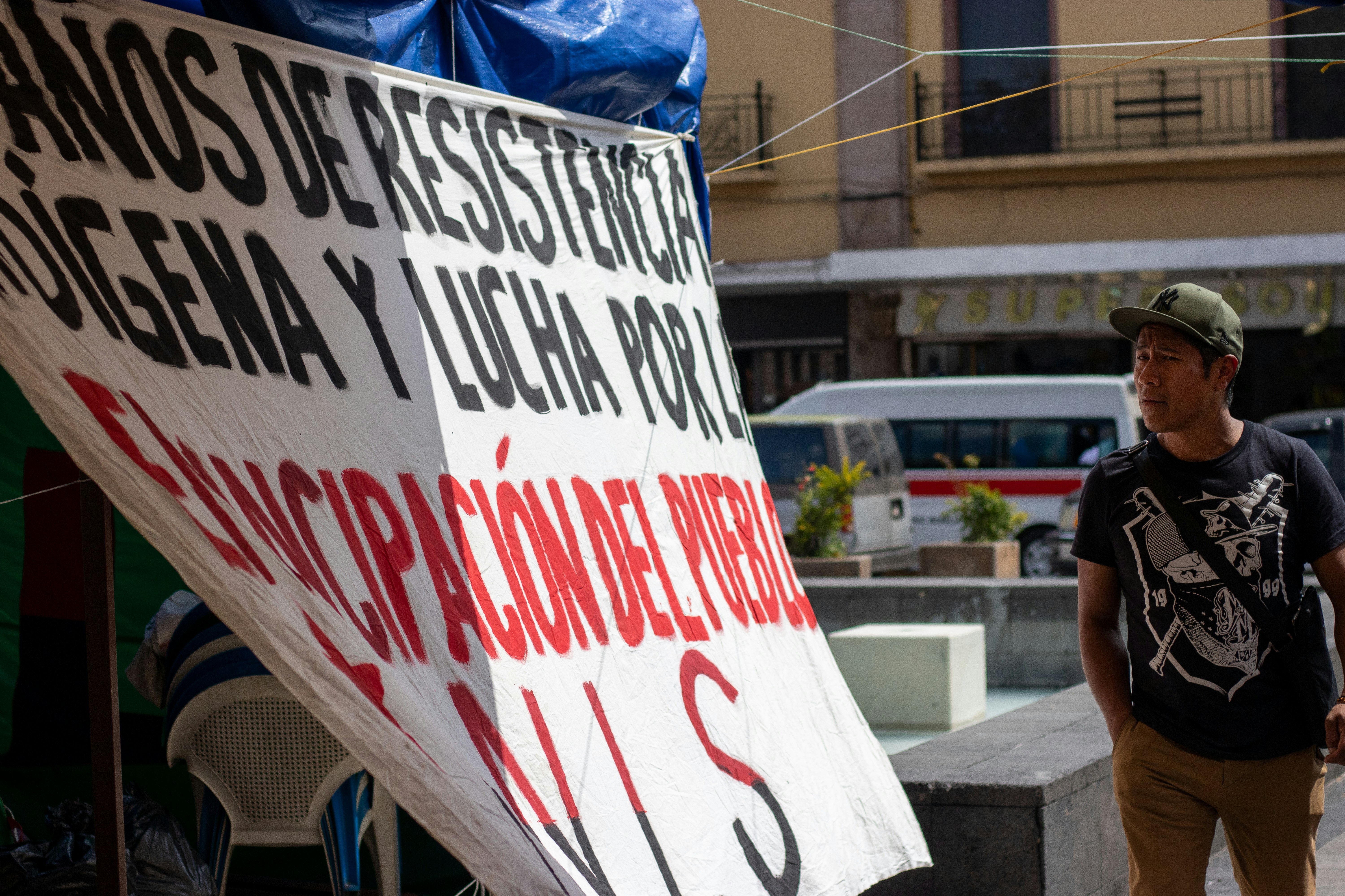 man looking at hanging sign
