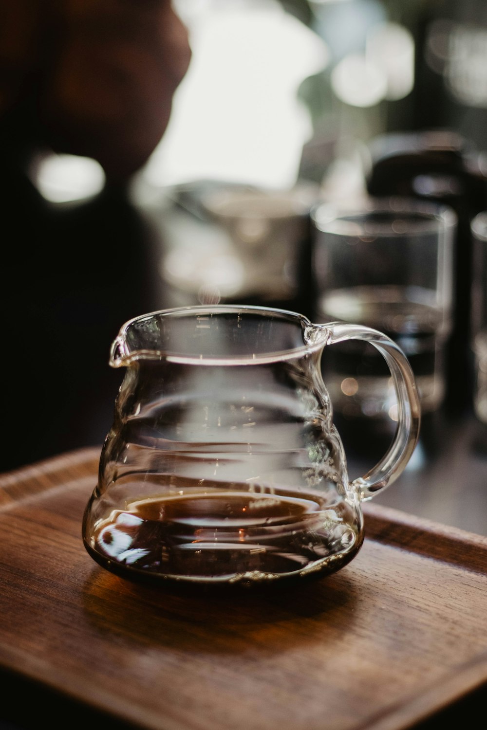 clear glass pitcher in table