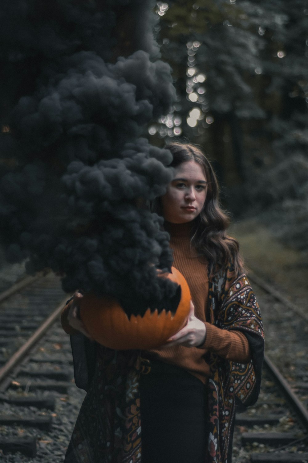 woman holding orange pumpkn