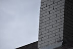 Close-up of a technician installing a kitchen chimney with careful precision.