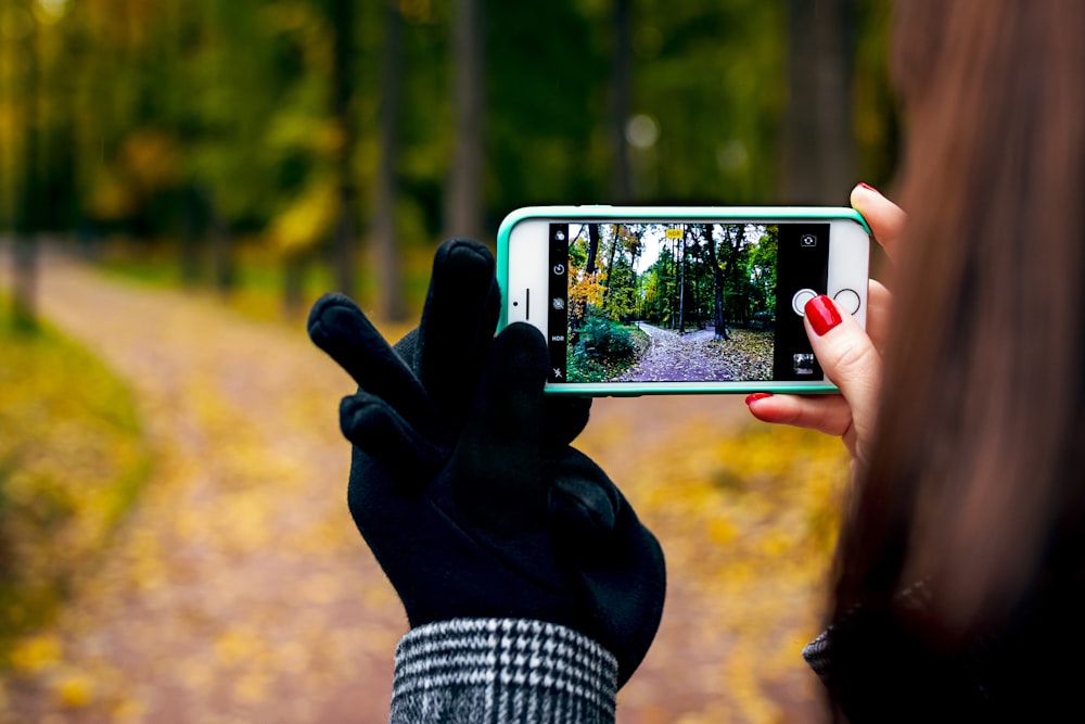 woman taking photo using iPhone