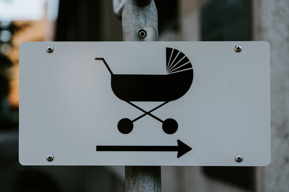 selective focus photography of black bassinet with arrow sign