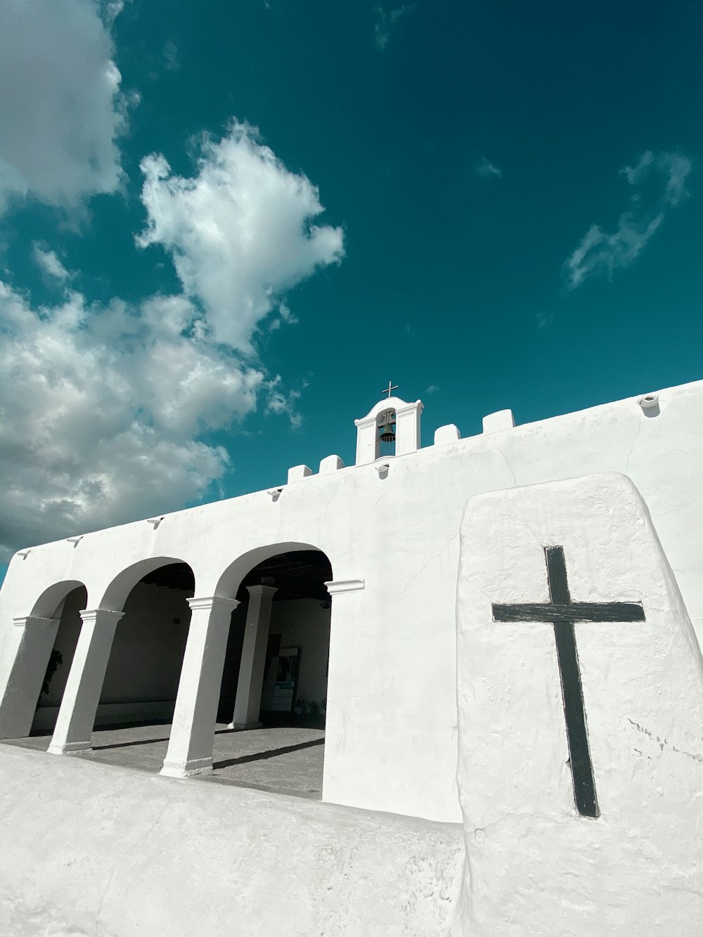 low-angle photography of a white cathedral under a blue sky