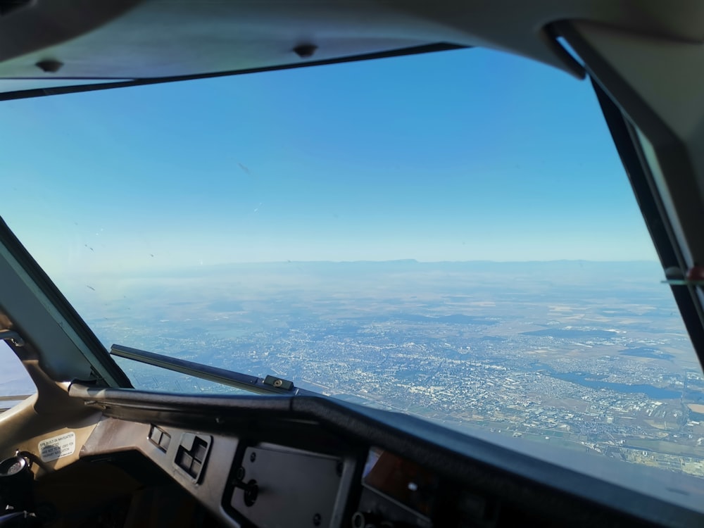 view of land mass inside airplane cockpit