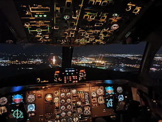 Nighttime flight scene in Microsoft Flight Simulator 2024 with illuminated NDB markers derived from real AM radio stations.