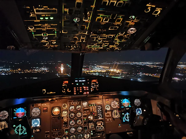 Nighttime flight scene in Microsoft Flight Simulator 2024 with illuminated NDB markers derived from real AM radio stations.