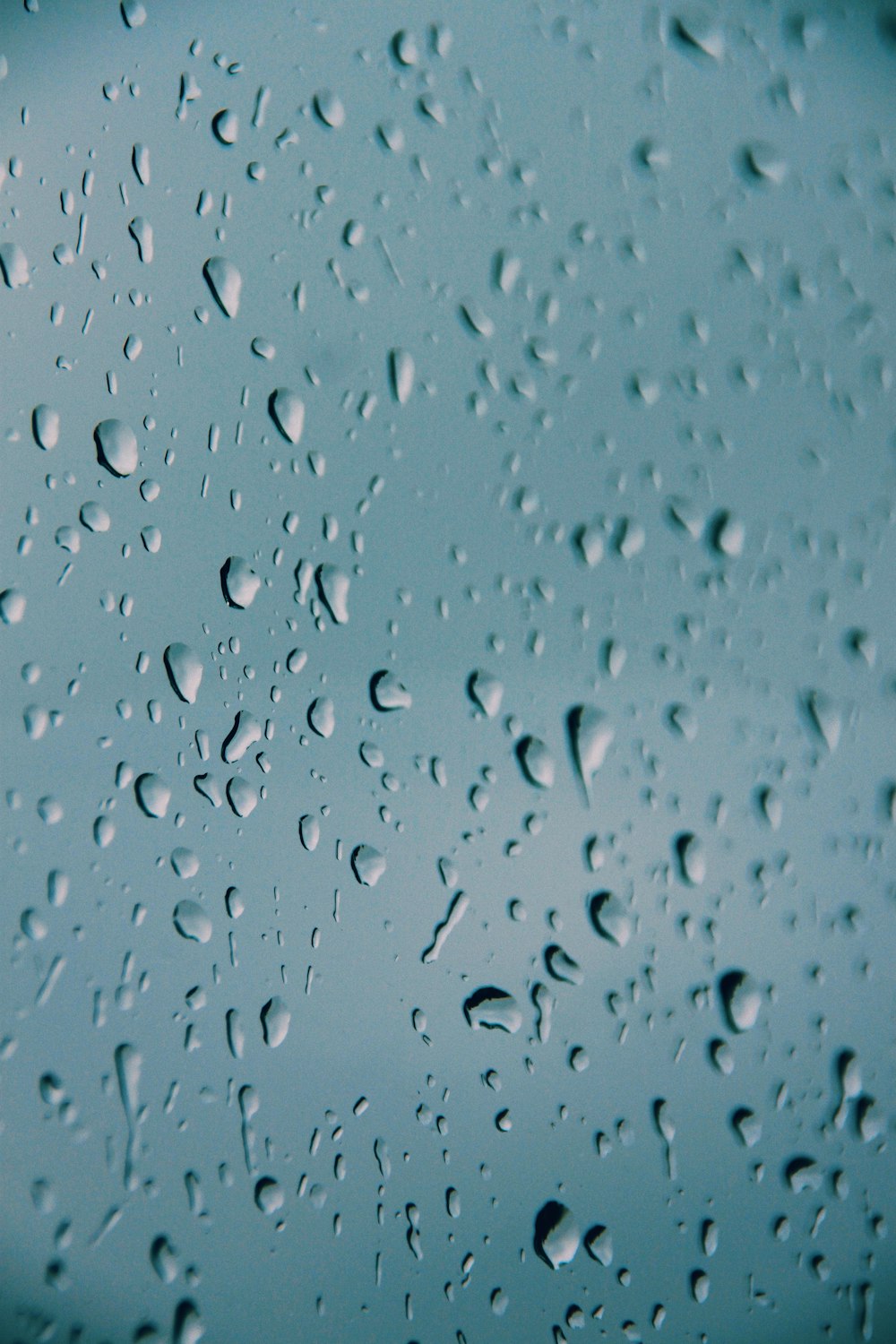 a close up of water droplets on a blue surface