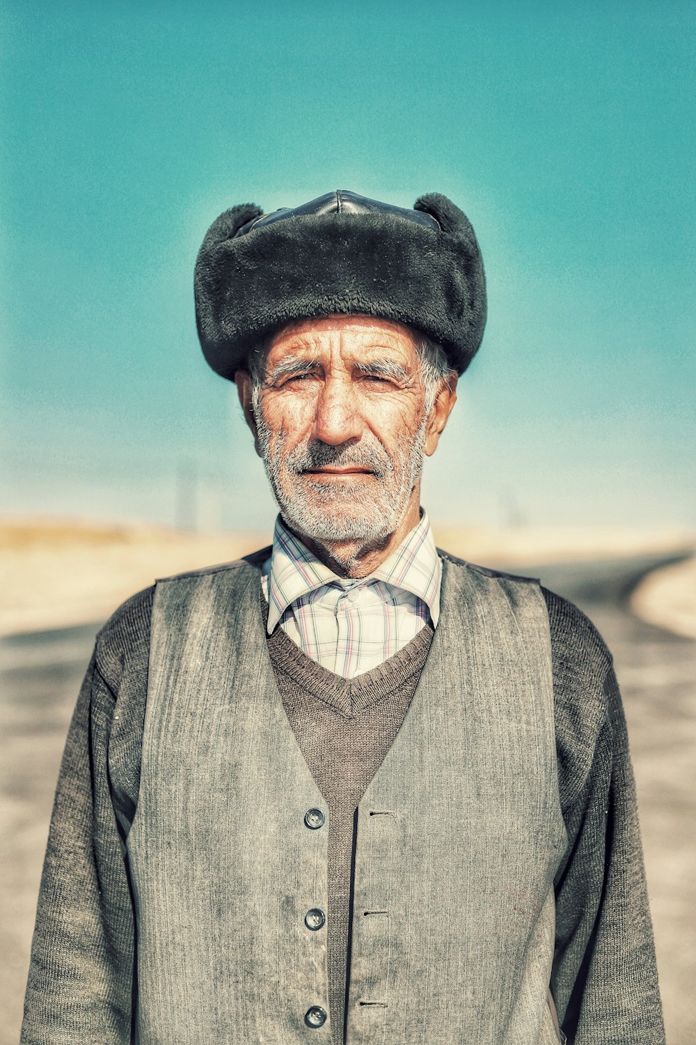 man wearing hat while standing on open field