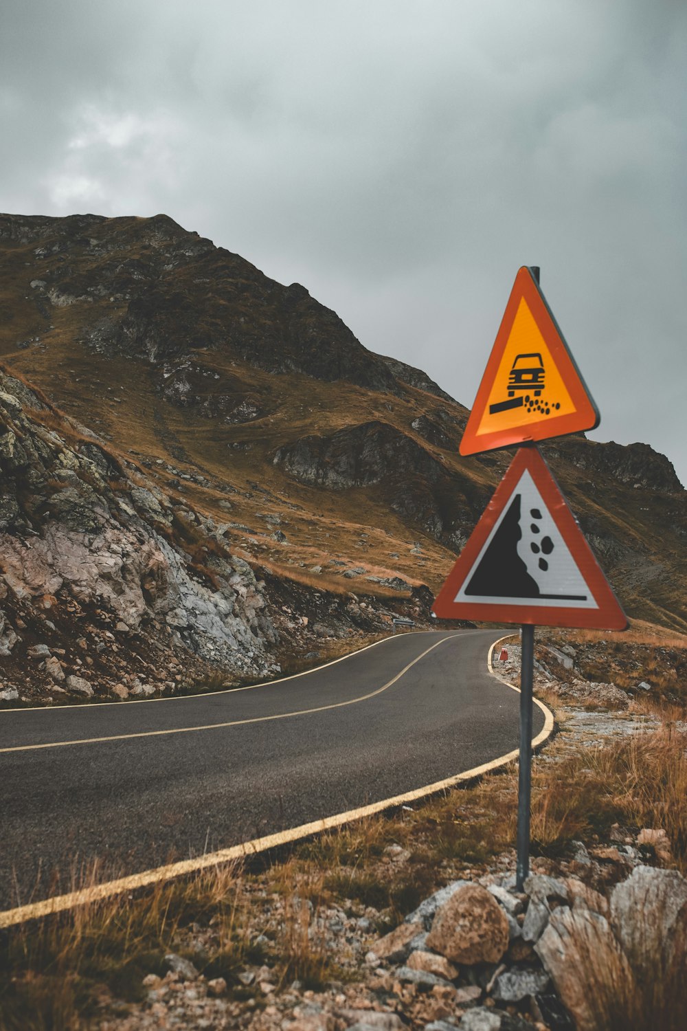 two orange and red triangular signages