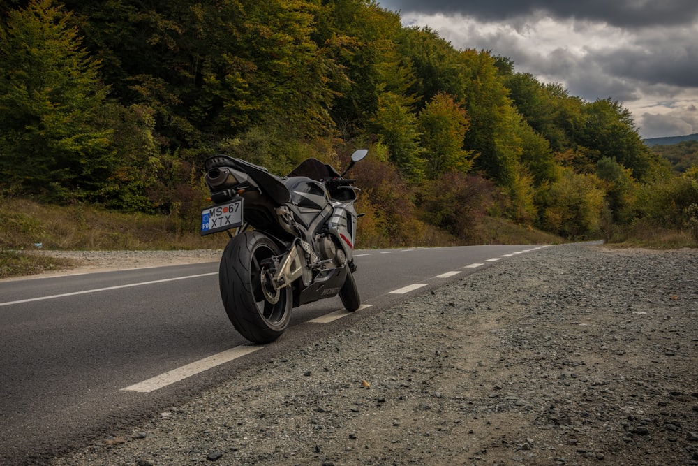 black motorcycle parked on road at daytime