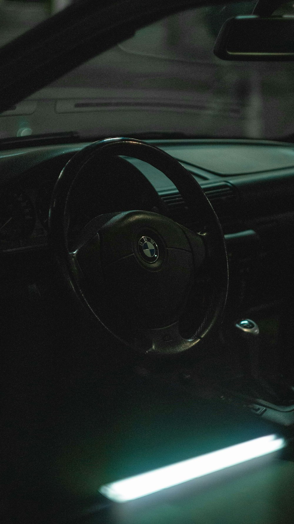 black BMW vehicle steering wheel close-up photography