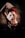 A person with red hair and freckles focuses intensely on a playing card seemingly suspended in mid-air between their raised hands. The background is dark, adding to the mysterious atmosphere.