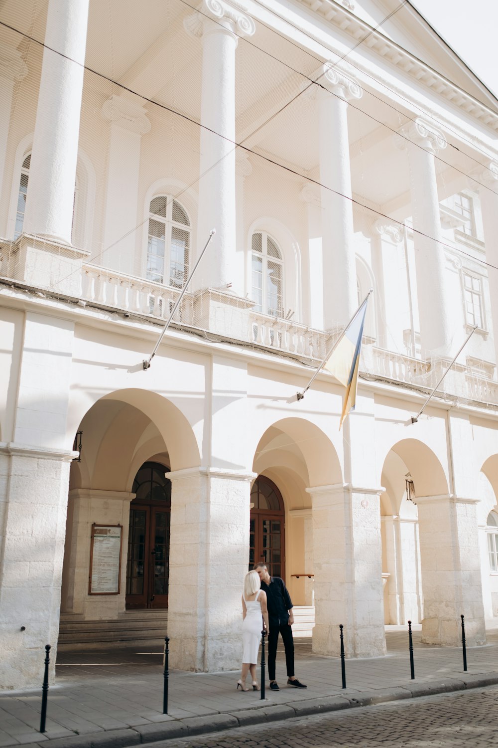 couple kissing near the building