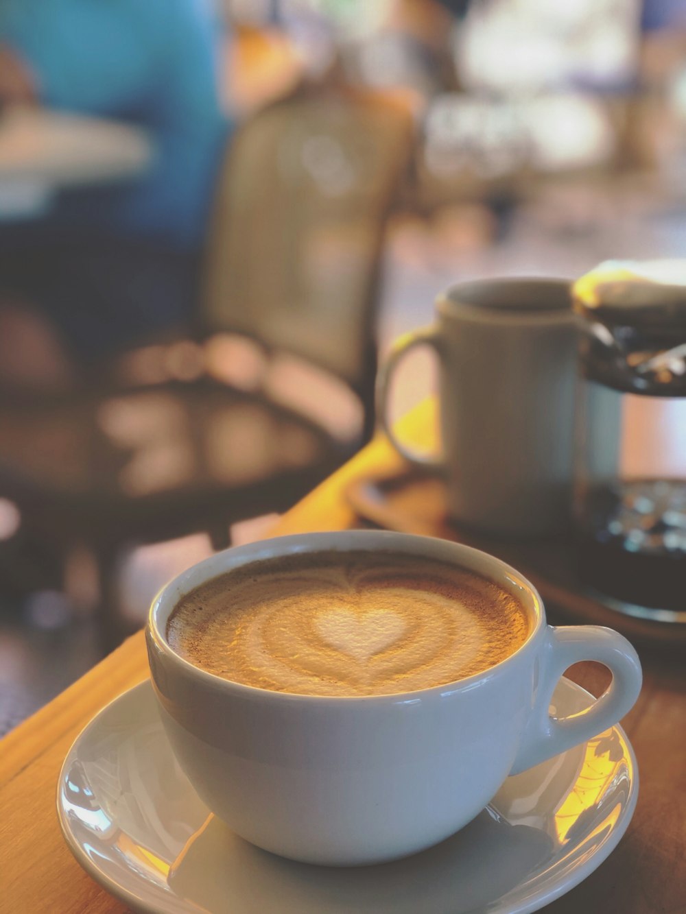 cappuccino in ceramic teacup on wooden table