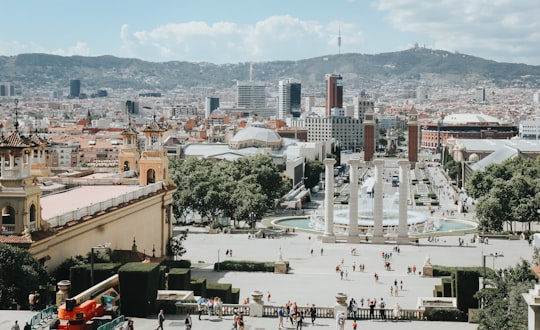 people near houses in Plaça d'Espanya Spain