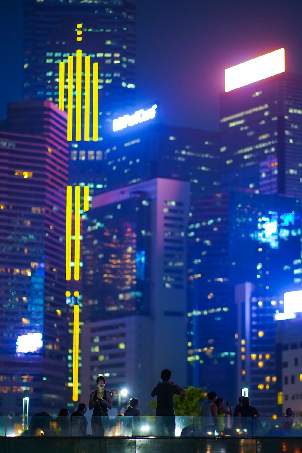 people near high rise building at nighttime