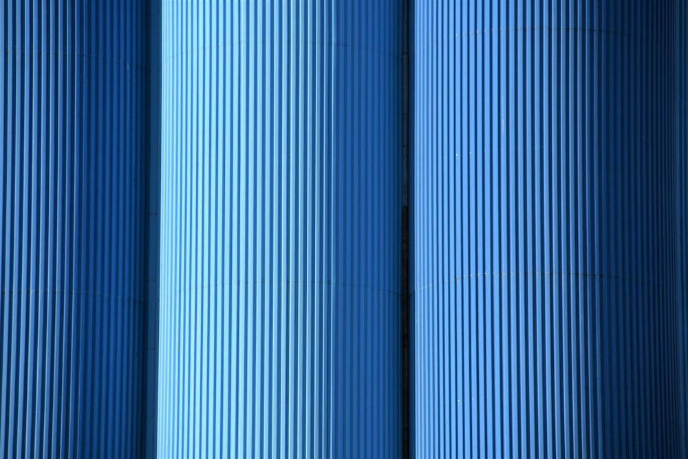 a close up of a row of blue pipes