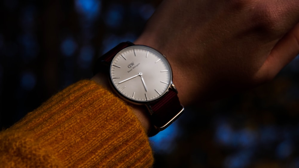 round silver-colored and white analog watch