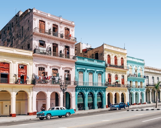 two cars parked outside building in Central Park Cuba