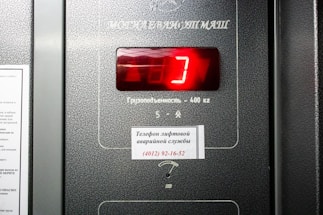 a close up of a machine with a red clock