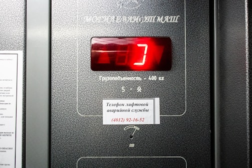 a close up of a machine with a red clock