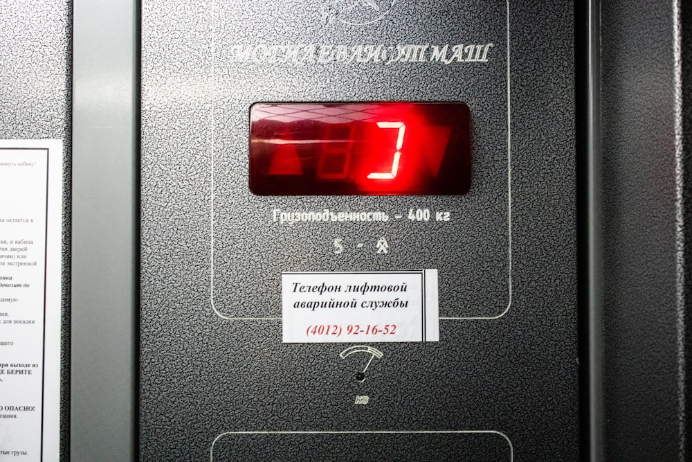a close up of a machine with a red clock