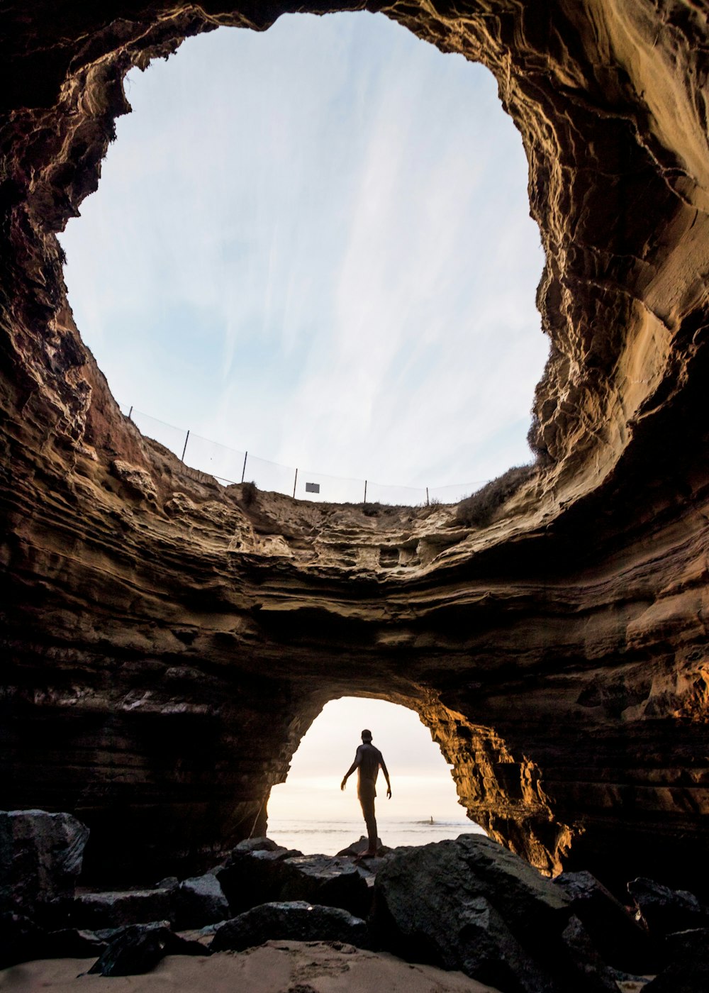 man standing on rock formations