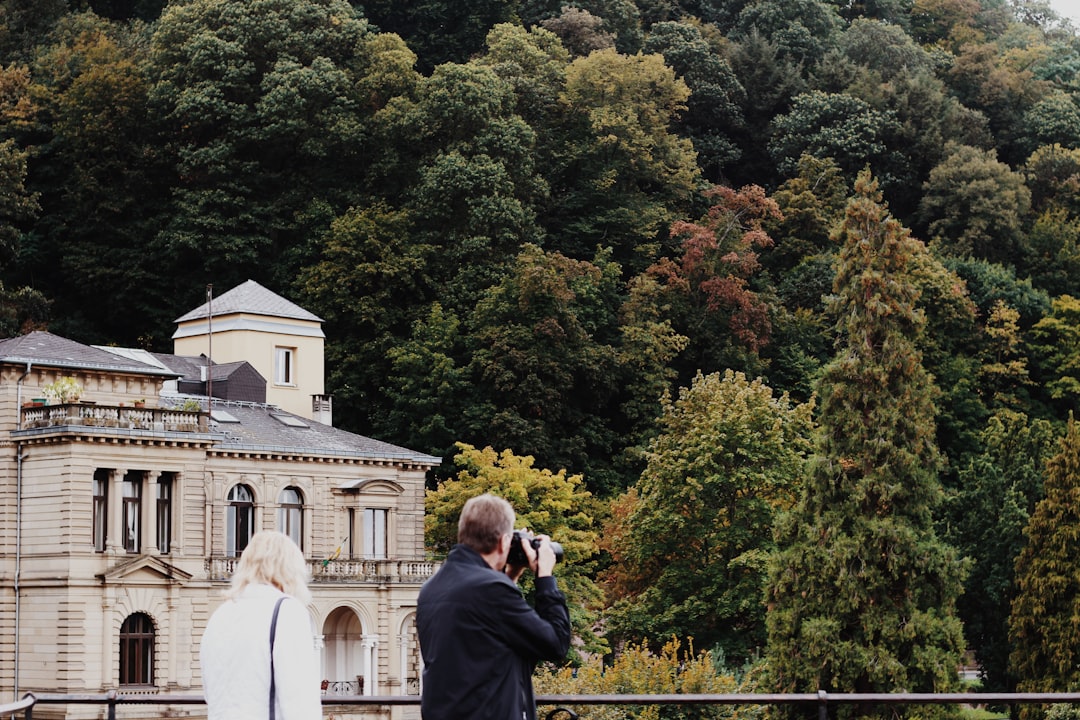 man taking photo near the building