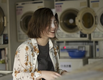 smiling woman wearing white and brown floral top