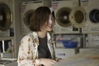 A friendly customer service representative wearing a headset, smiling and ready to assist with laundry bookings.