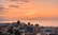 View of the coastal edge of Viña del Mar with colorful buildings and the ocean at sunset.