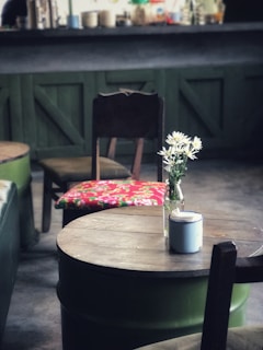 A rustic wooden table set with various mead bottles and glasses, surrounded by Viking-themed decor.