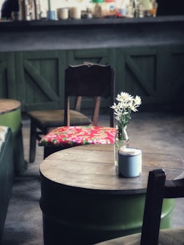 A rustic wooden table set with various mead bottles and glasses, surrounded by Viking-themed decor.