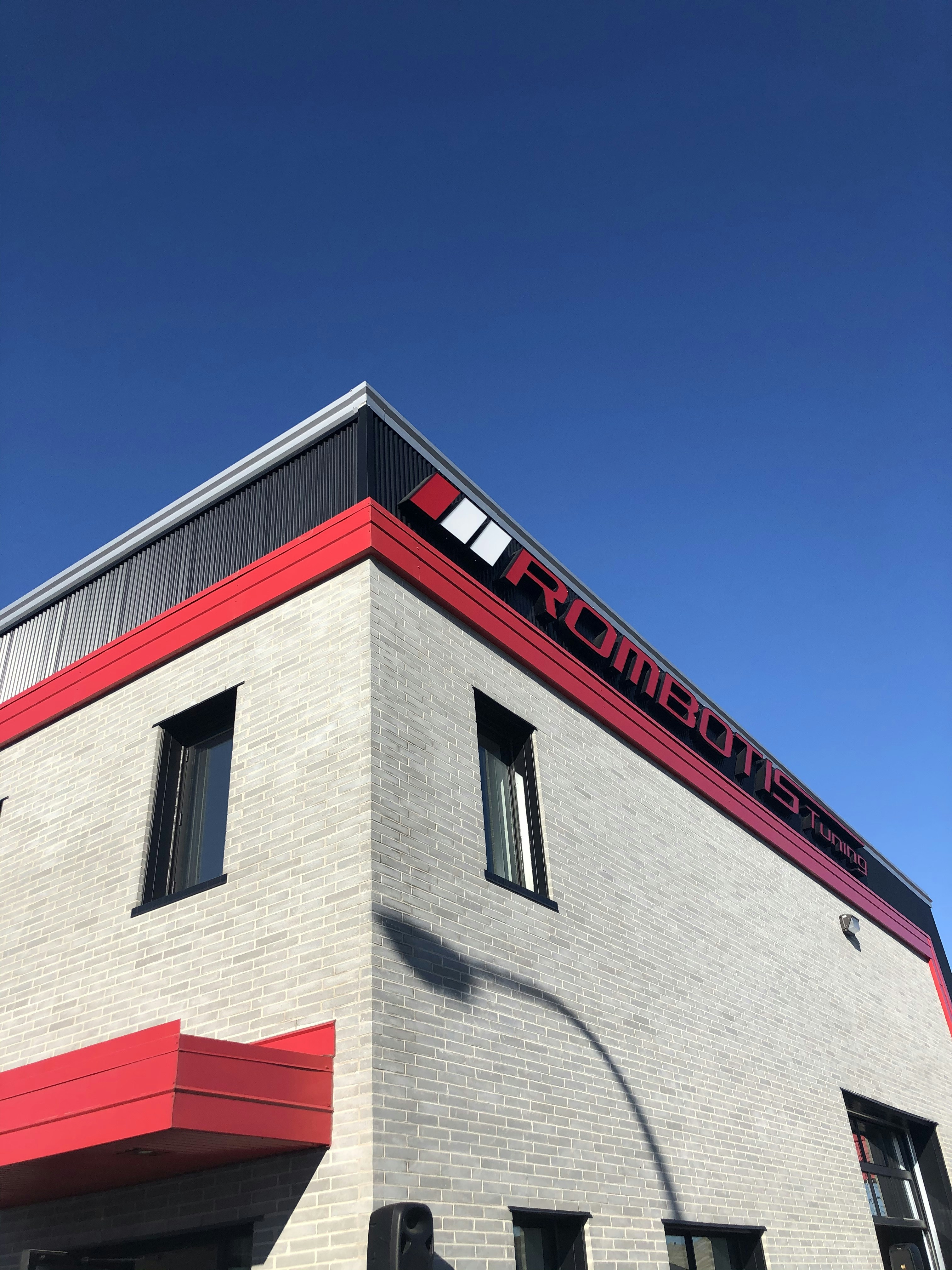 gray, red, and gray buildings under blue sky