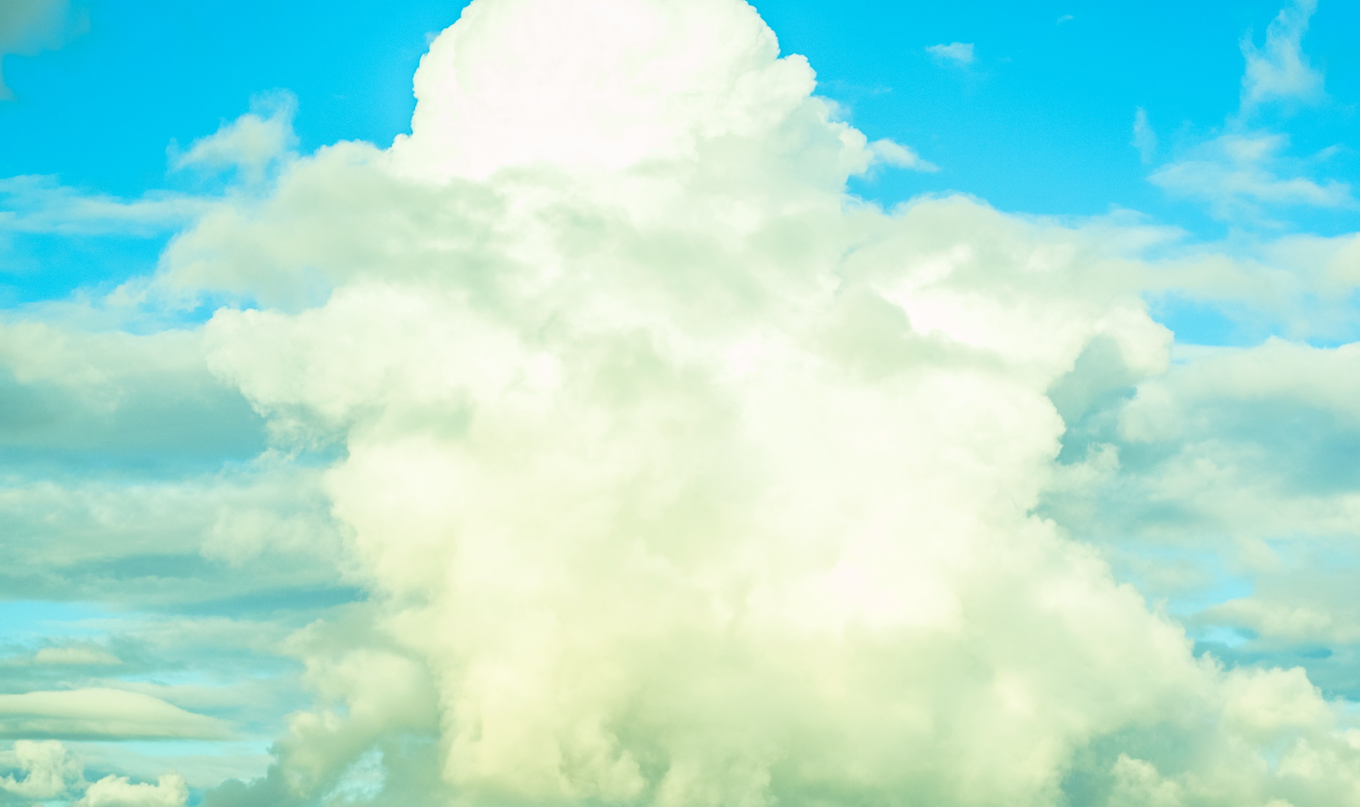 woman wearing yellow long-sleeved dress under white clouds and blue sky during daytime