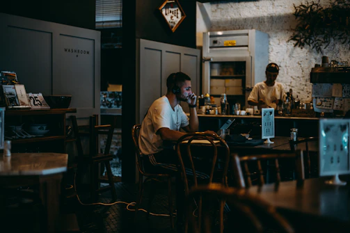 A quiet café corner where an author is typing away on a laptop, surrounded by books and inspiration.