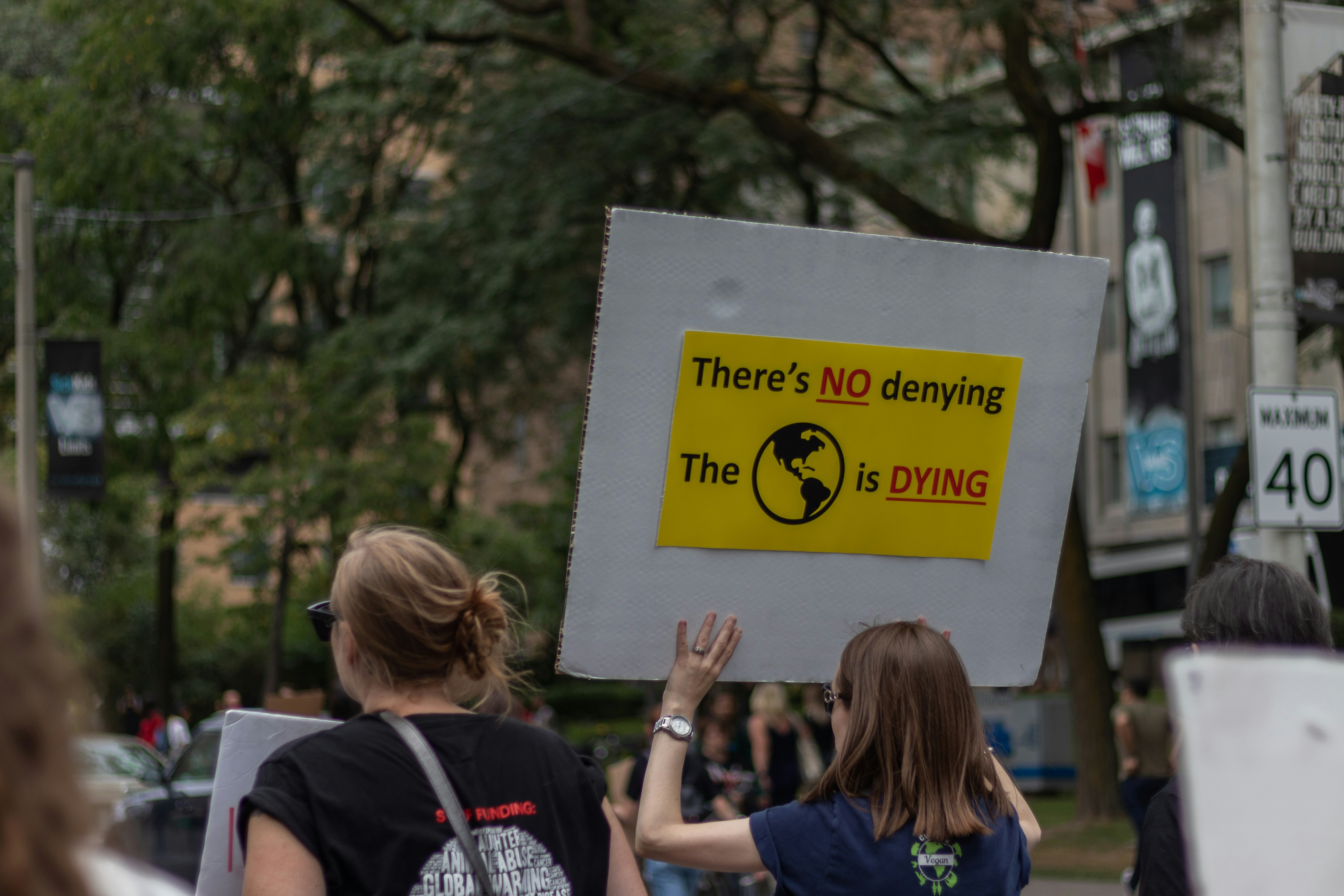 woman holding protest poster