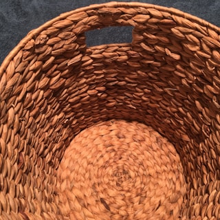 Detail of bamboo basket handles, emphasizing smooth curves and the natural finish of the material.