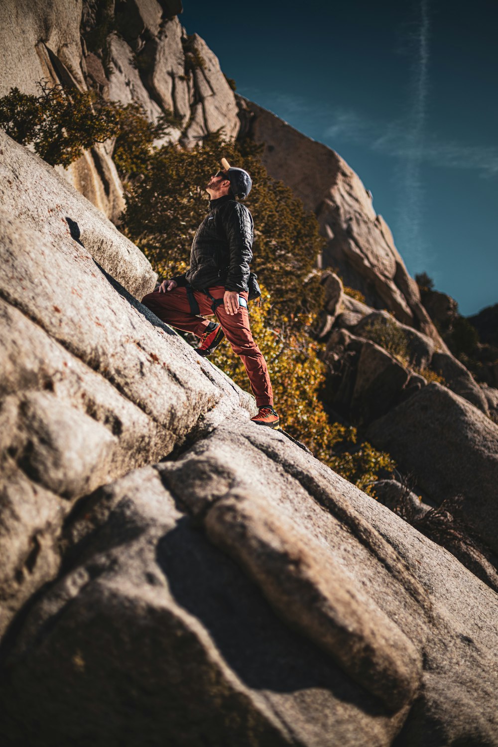 man standing on gray rock